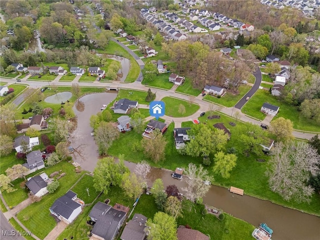 drone / aerial view with a water view and a residential view