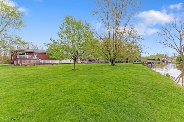 view of yard featuring a deck with water view