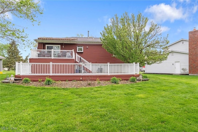 back of house featuring a yard and a deck