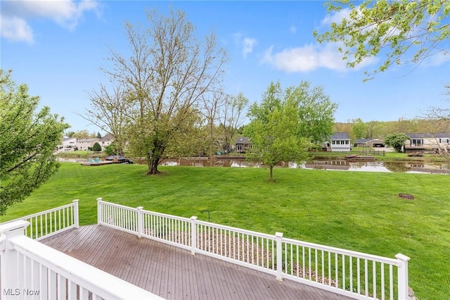 deck with a lawn and a water view