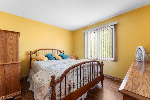 bedroom with baseboards and wood finished floors