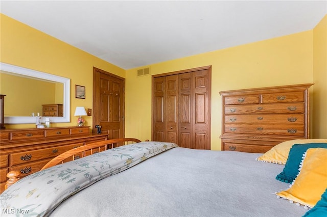 bedroom with visible vents and a closet