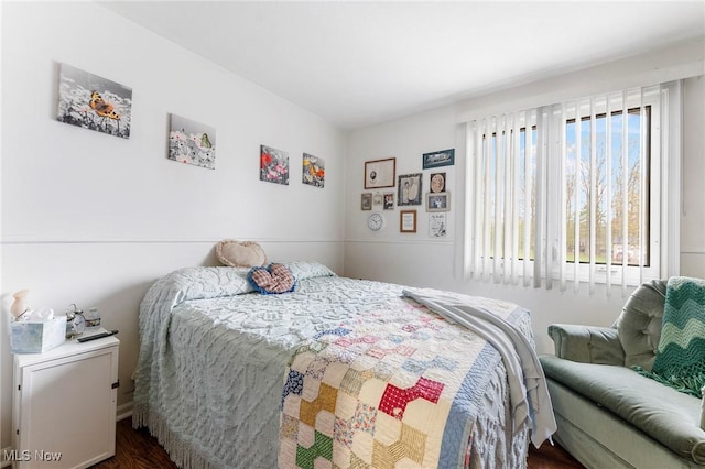 bedroom featuring dark wood finished floors