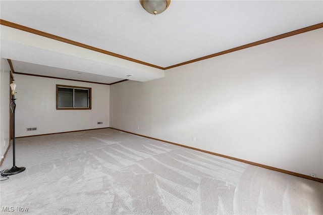empty room featuring baseboards, ornamental molding, light carpet, and visible vents