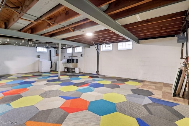 basement featuring washer / clothes dryer, tile patterned floors, and plenty of natural light