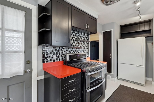 kitchen with freestanding refrigerator, open shelves, double oven range, and tasteful backsplash