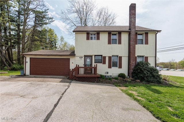 4682 State Route 43, Kent, OH 44240 - colonial inspired home with an attached garage, aphalt driveway, and a chimney