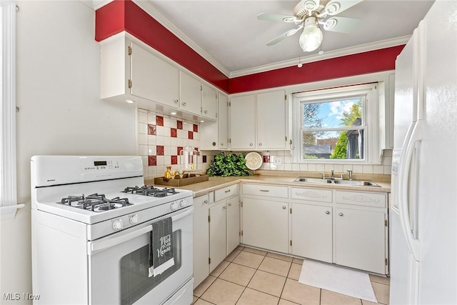 kitchen with light tile patterned flooring, white appliances, ceiling fan, light countertops, and tasteful backsplash
