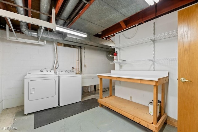 unfinished basement with separate washer and dryer and concrete block wall