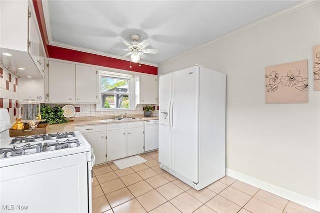 kitchen with a sink, white appliances, light countertops, a ceiling fan, and tasteful backsplash