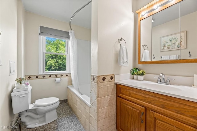 full bathroom with toilet, tiled shower / bath, speckled floor, and vanity