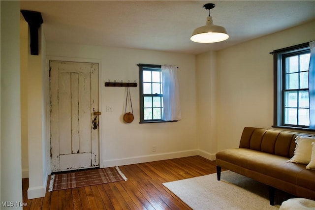 living area with baseboards and hardwood / wood-style floors