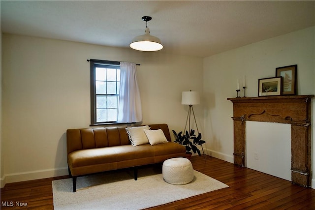 living area with baseboards and dark wood-style flooring