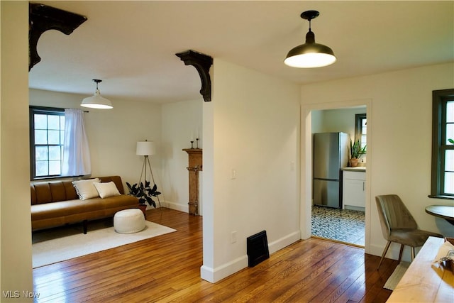 living area with baseboards and hardwood / wood-style floors