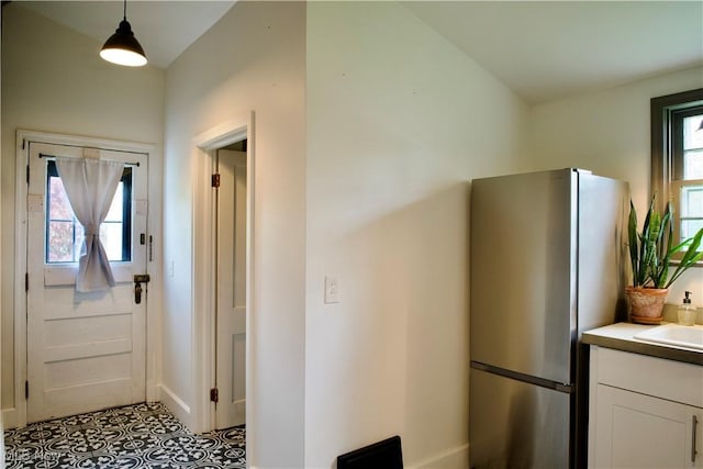 foyer entrance with plenty of natural light and baseboards