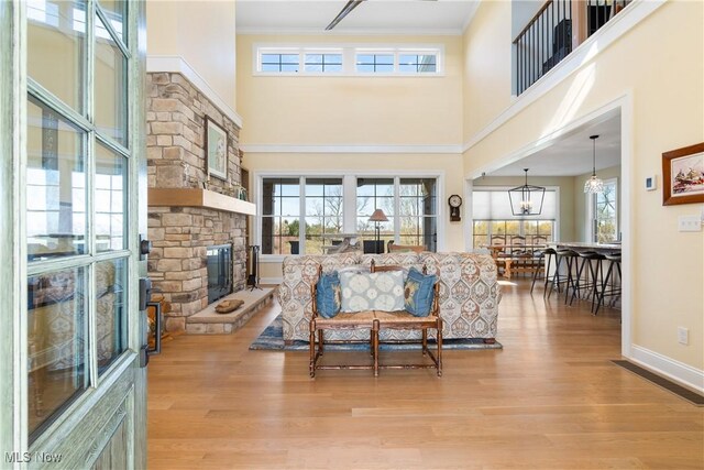 46748 New London Eastern Rd, New London, OH 44851 - living area with a healthy amount of sunlight, a towering ceiling, light wood-style flooring, and visible vents