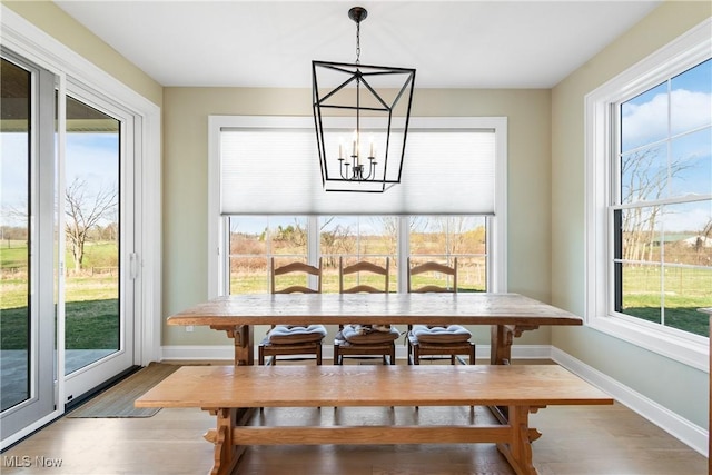 46748 New London Eastern Rd, New London, OH 44851 - dining room with baseboards, wood finished floors, and a chandelier