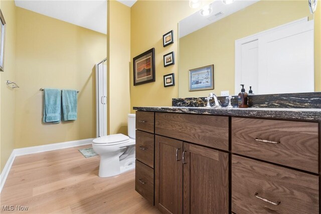 46748 New London Eastern Rd, New London, OH 44851 - bathroom with a stall shower, wood finished floors, vanity, baseboards, and toilet