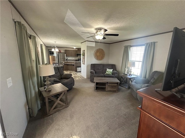 living room featuring a textured ceiling, ceiling fan, and light colored carpet