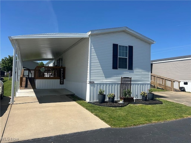 view of front of house with a front yard and an attached carport