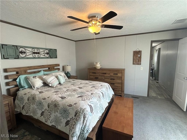 bedroom featuring crown molding, a decorative wall, carpet flooring, and a textured ceiling