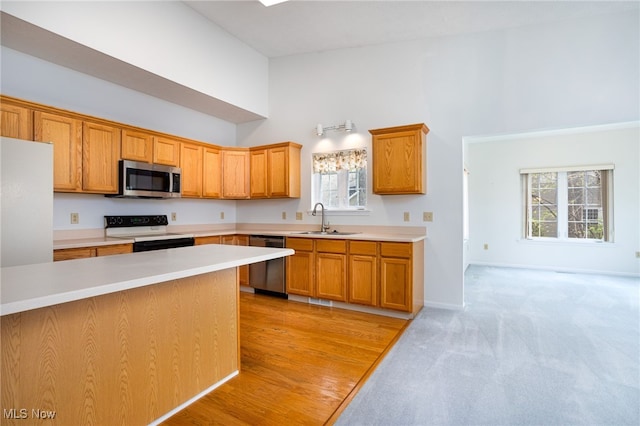 11235 Frederick Ln, Twinsburg, OH 44087 - kitchen featuring range with electric cooktop, a sink, high vaulted ceiling, stainless steel microwave, and dishwashing machine