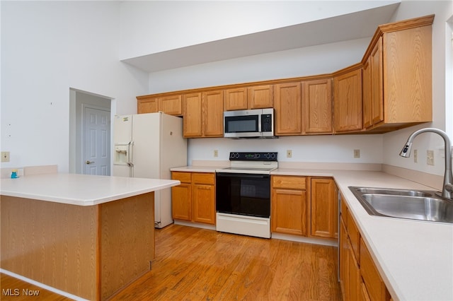 11235 Frederick Ln, Twinsburg, OH 44087 - kitchen with a sink, range with electric cooktop, white fridge with ice dispenser, stainless steel microwave, and light wood-type flooring