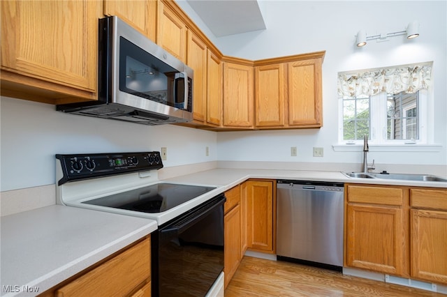 11235 Frederick Ln, Twinsburg, OH 44087 - kitchen with a sink, light wood-style flooring, appliances with stainless steel finishes, and light countertops