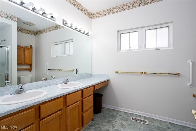 11235 Frederick Ln, Twinsburg, OH 44087 - full bathroom with baseboards, toilet, a shower with door, and a sink