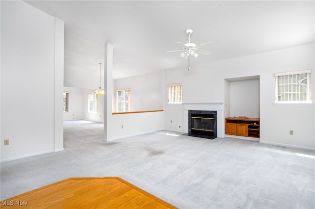 11235 Frederick Ln, Twinsburg, OH 44087 - unfurnished living room with a high end fireplace, baseboards, a ceiling fan, and light colored carpet