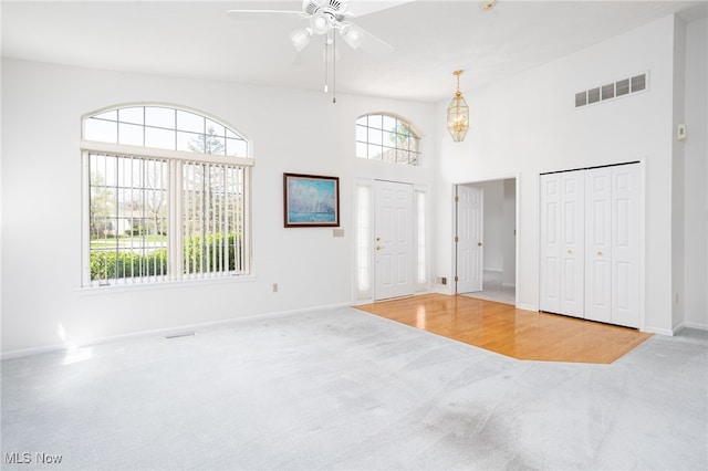 11235 Frederick Ln, Twinsburg, OH 44087 - carpeted entryway featuring baseboards, a high ceiling, a ceiling fan, and visible vents