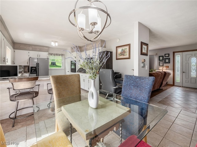 dining room with light tile patterned flooring and a chandelier
