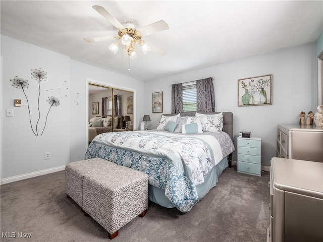 bedroom with a ceiling fan, baseboards, dark carpet, and a closet