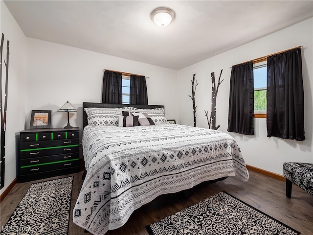 bedroom featuring baseboards and wood finished floors