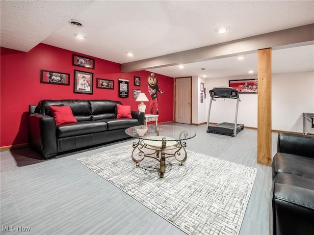 living room featuring baseboards, recessed lighting, and wood finished floors