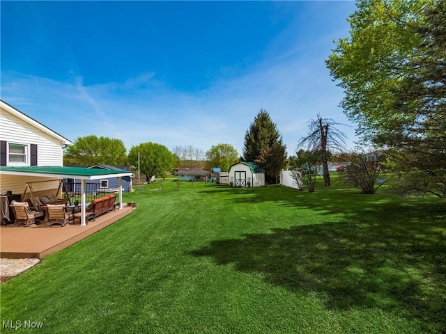 view of yard with a storage unit, an outdoor structure, and a patio