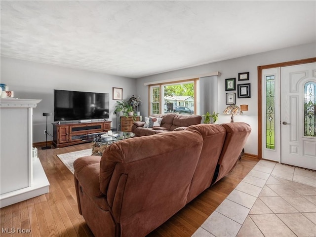 living room with baseboards and light wood-style flooring