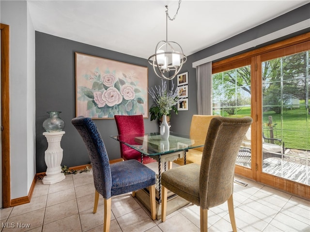dining area with light tile patterned floors, baseboards, visible vents, and a chandelier
