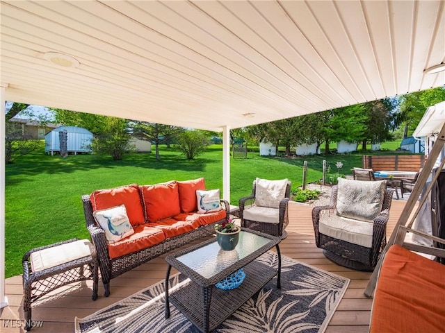 view of patio featuring an outdoor living space and a shed