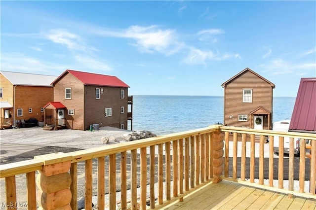 wooden terrace featuring a water view