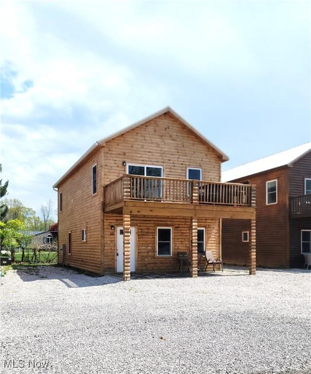 back of house with a deck