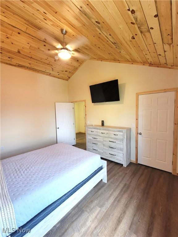 bedroom featuring wood ceiling, dark wood-style flooring, and lofted ceiling