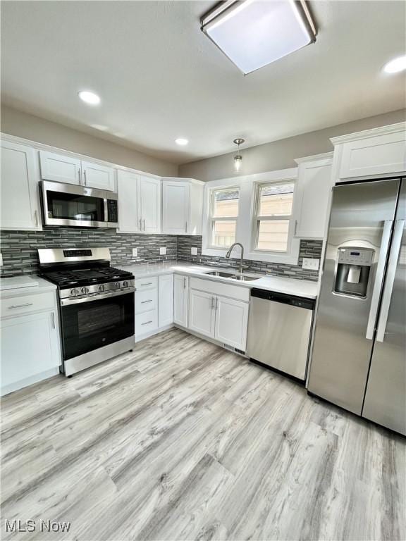 kitchen featuring a sink, white cabinetry, appliances with stainless steel finishes, and light countertops