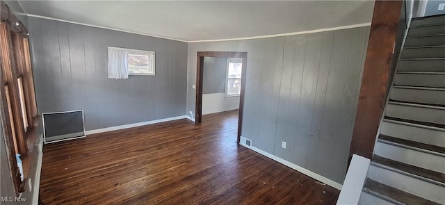 9910 Zimmer Ave, Cleveland, OH 44102 - empty room with stairway, baseboards, dark wood-style flooring, and wooden walls