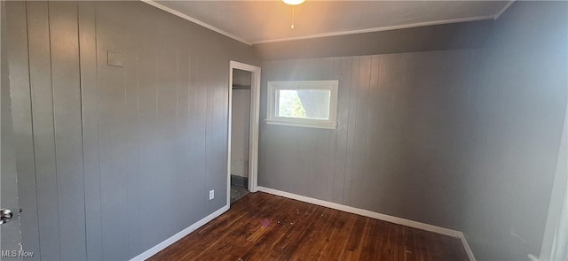 9910 Zimmer Ave, Cleveland, OH 44102 - empty room featuring crown molding, baseboards, dark wood-style floors, and wooden walls