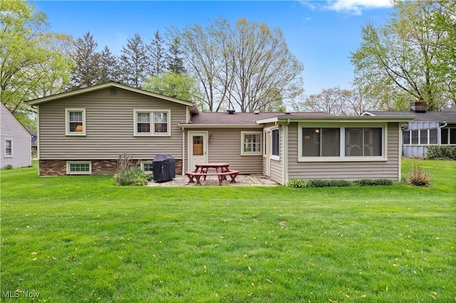 back of house with a patio and a yard
