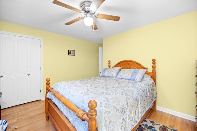 bedroom with baseboards, ceiling fan, a closet, and wood finished floors