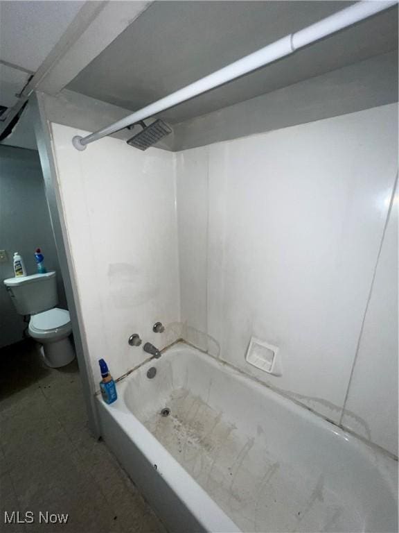 bathroom featuring  shower combination, tile patterned floors, and toilet