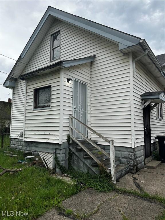 back of house featuring entry steps