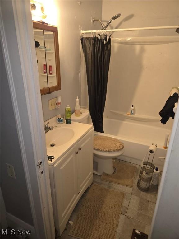 full bath featuring vanity, shower / bath combo, and toilet